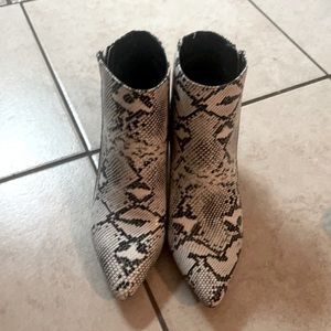 Pointed toe snake print booties with a heel